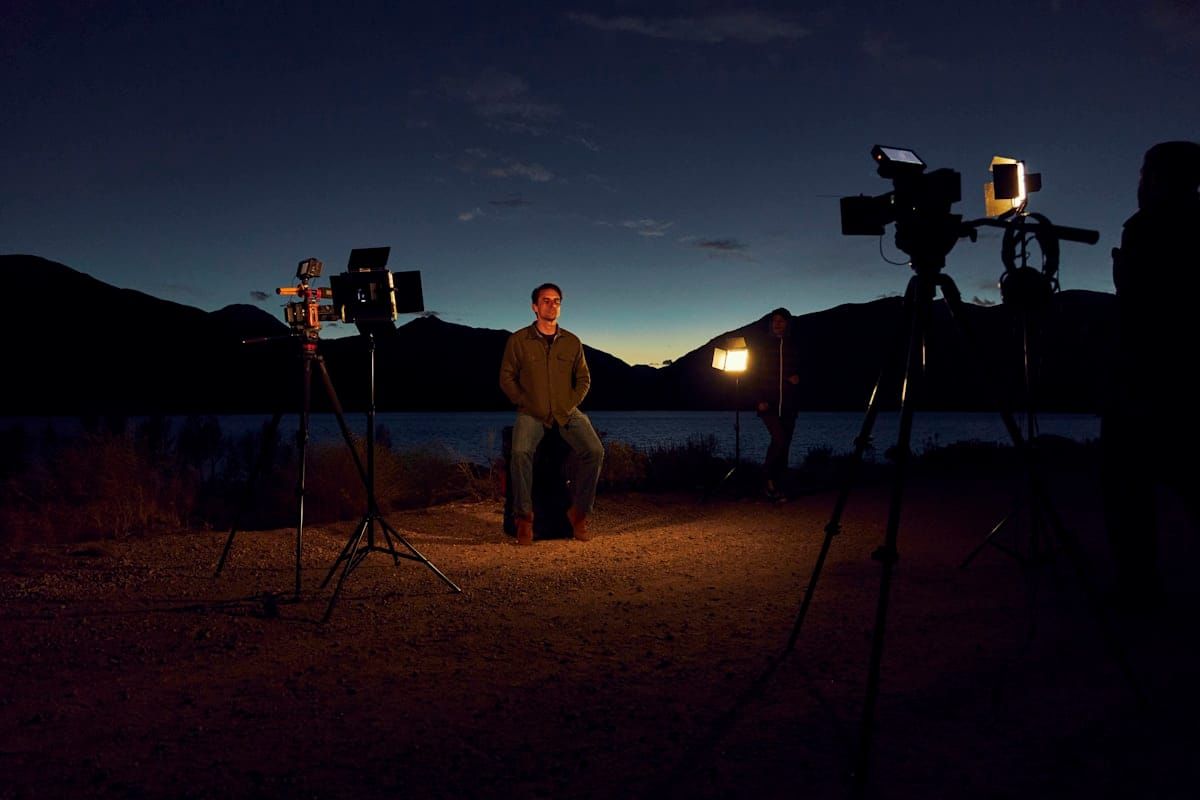 Behind the scenes of a video production shoot with camera equipment and crew