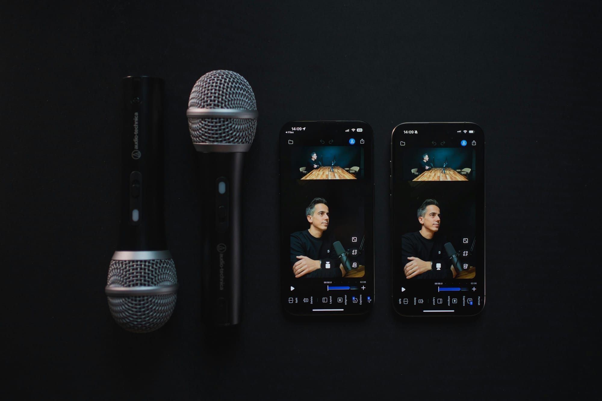 iPhone podcast recording setup with two microphones and mobile device on a desk