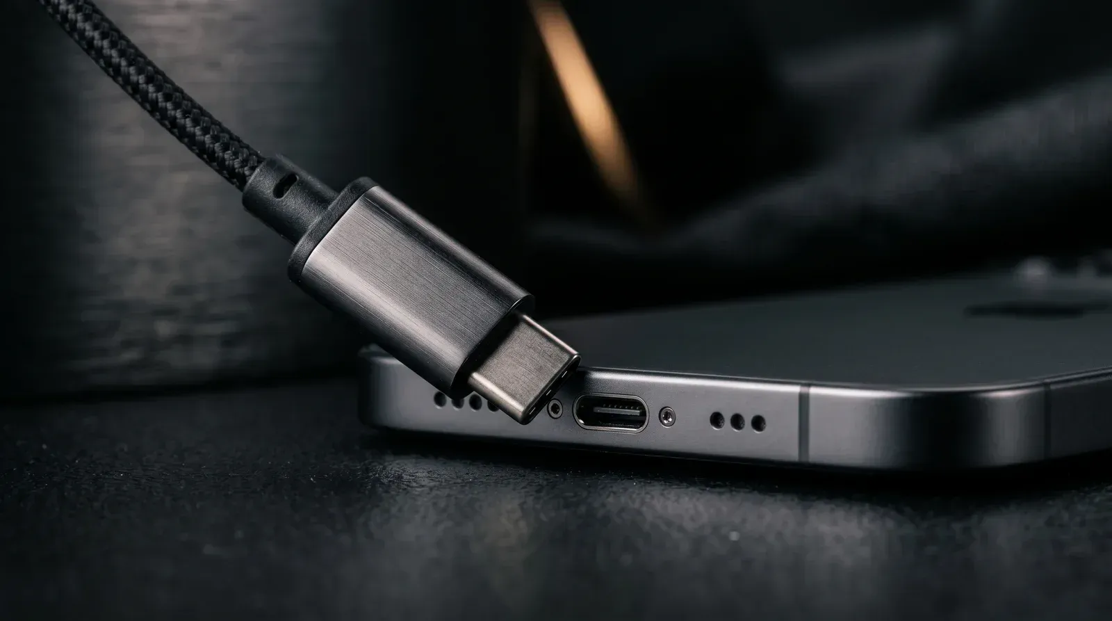 USB-C connector being plugged into the bottom port of a modern smartphone