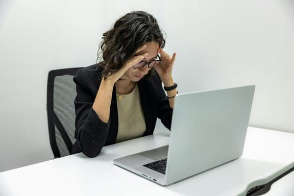 Person frustrated while waiting for slow video to load on laptop