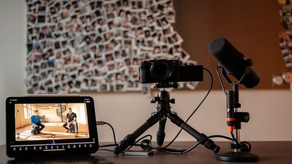 Creator recording with iPhone and wireless microphone setup in a studio