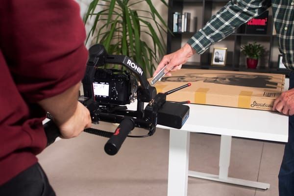 Product video filming setup with camera, lighting, and ecommerce products